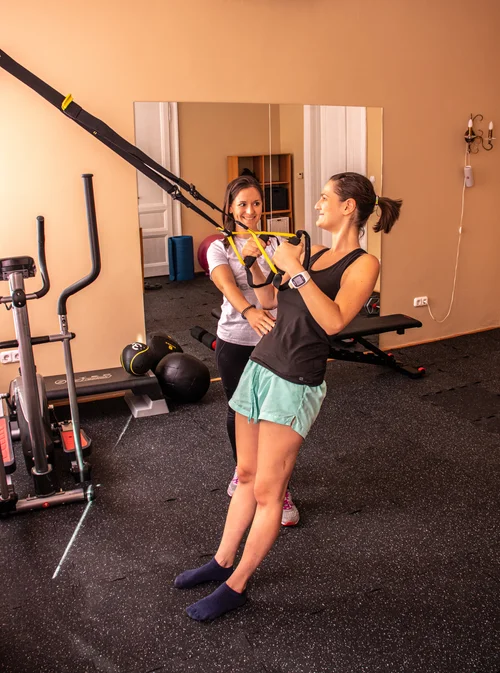 personal trainer with client TRX workout